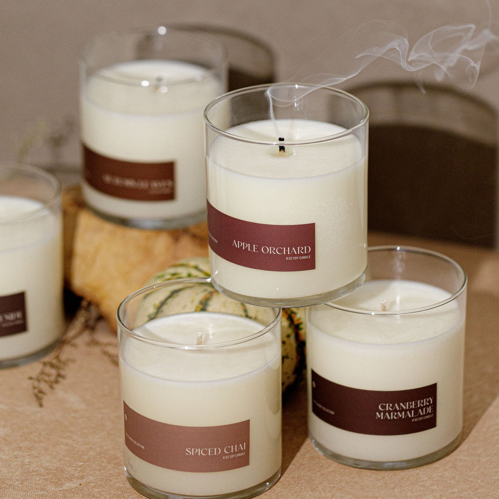 Soy candle gift set with multiple clear glass jars, brown labels, and white wax