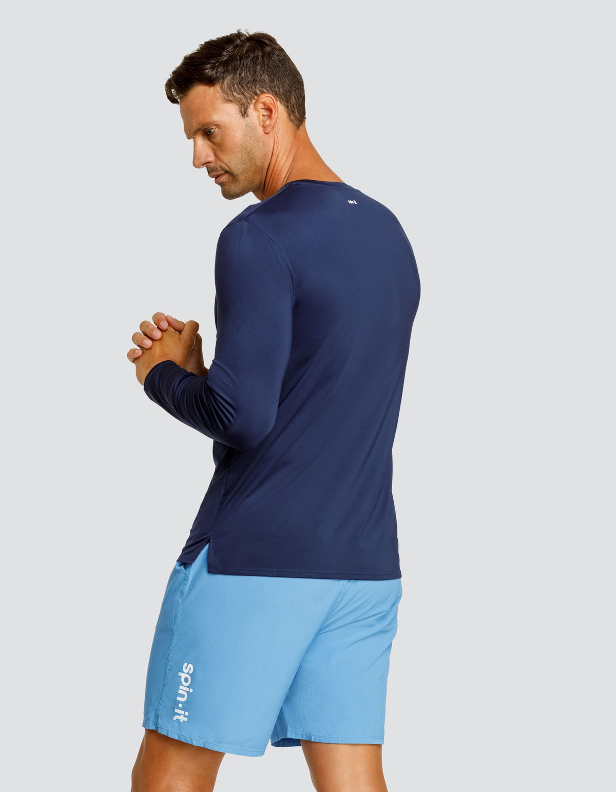 Navy long-sleeve crewneck top, side view with curved hem