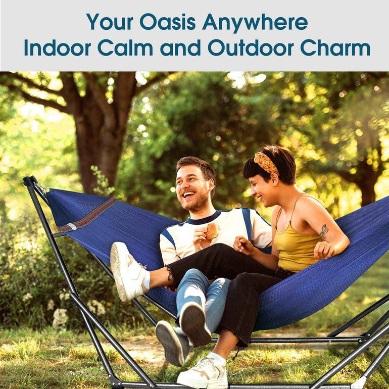 Navy-blue collapsible hammock with black steel stand, shown with two people relaxing.