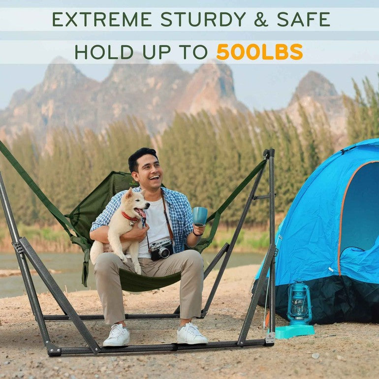 Green hammock chair with metal stand outdoors, holding a person and a dog