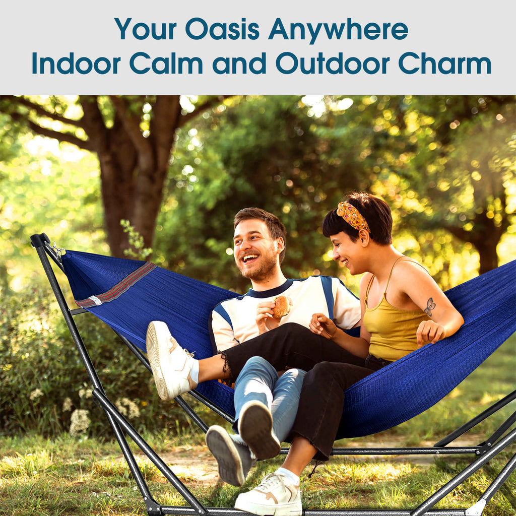 Blue collapsible hammock with stand outdoors with two people