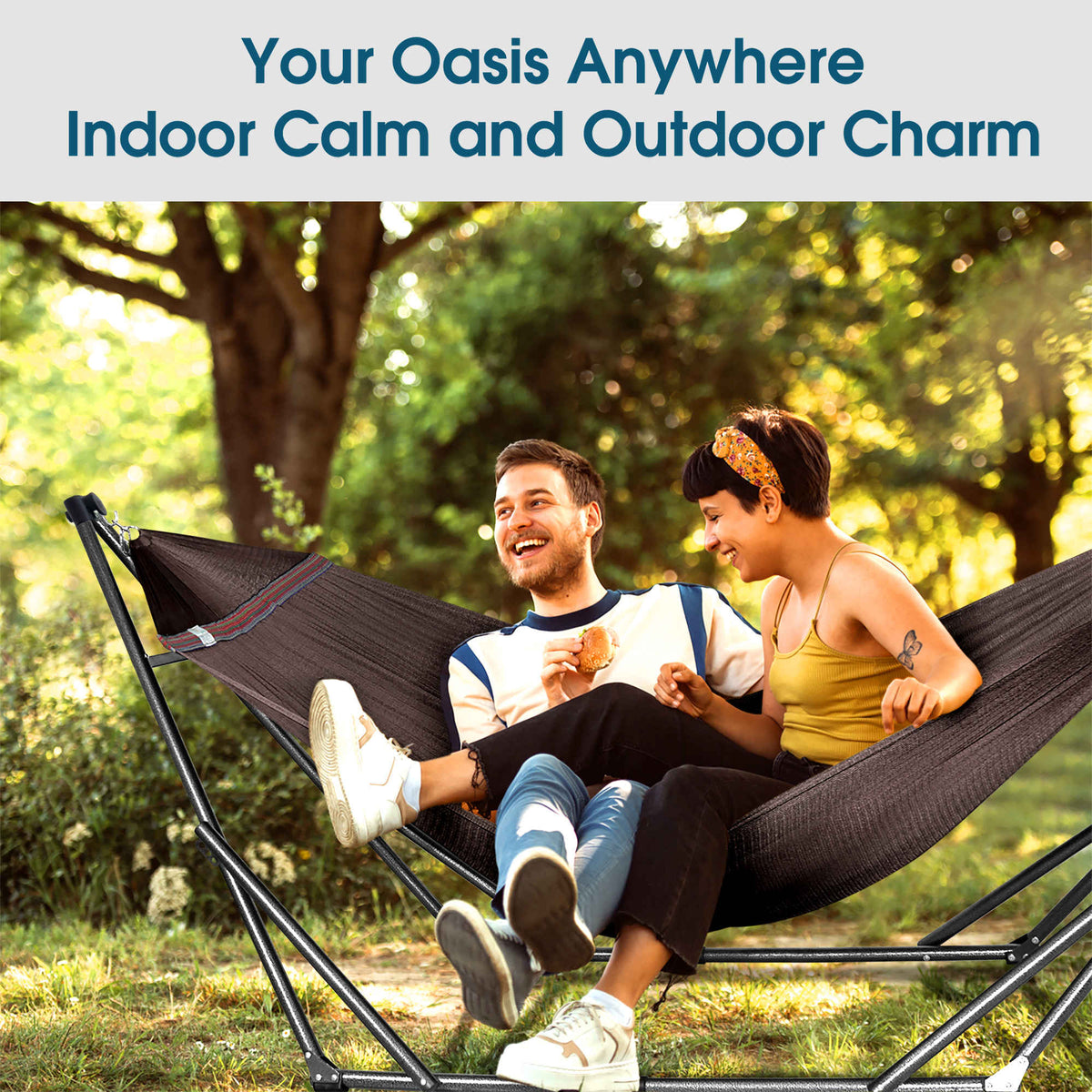 Dark fabric collapsible hammock with spreader bar stand and fabric seat.