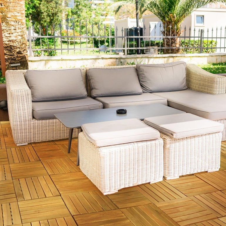 Outdoor wooden deck tiles in a tan slat pattern beneath patio furniture