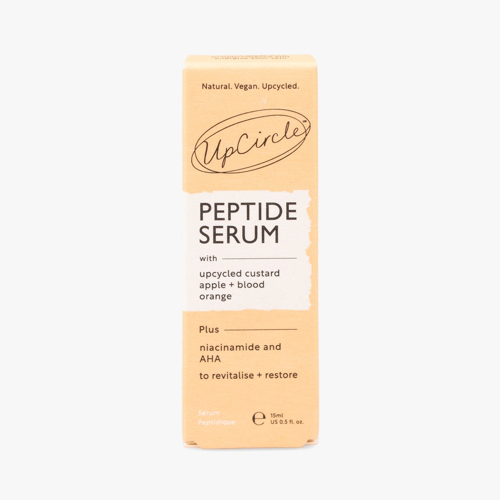 Peptide serum box packaging in peach with UpCircle branding and label
