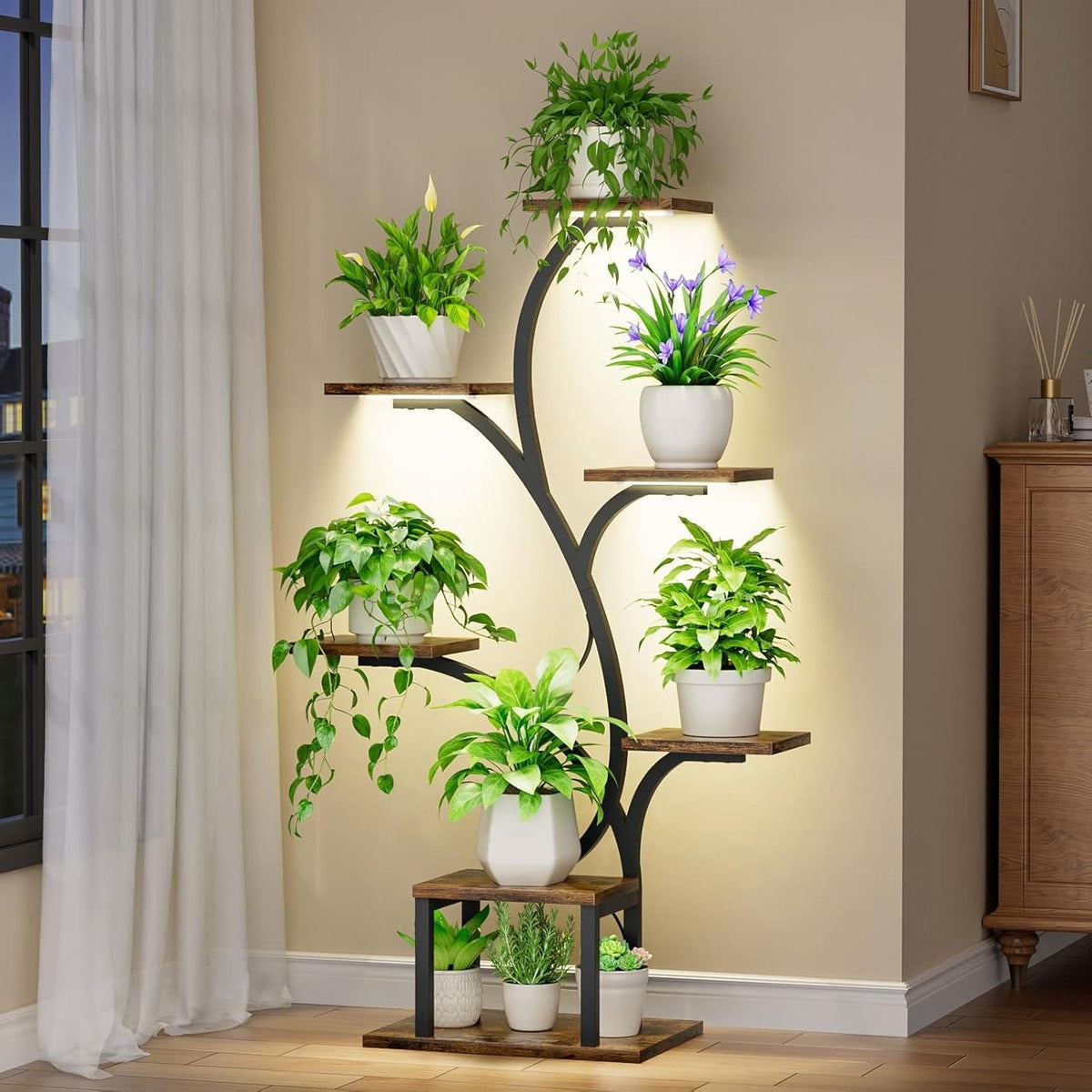 Indoor plant stand with curved black frame, five wooden shelves, grow light glow