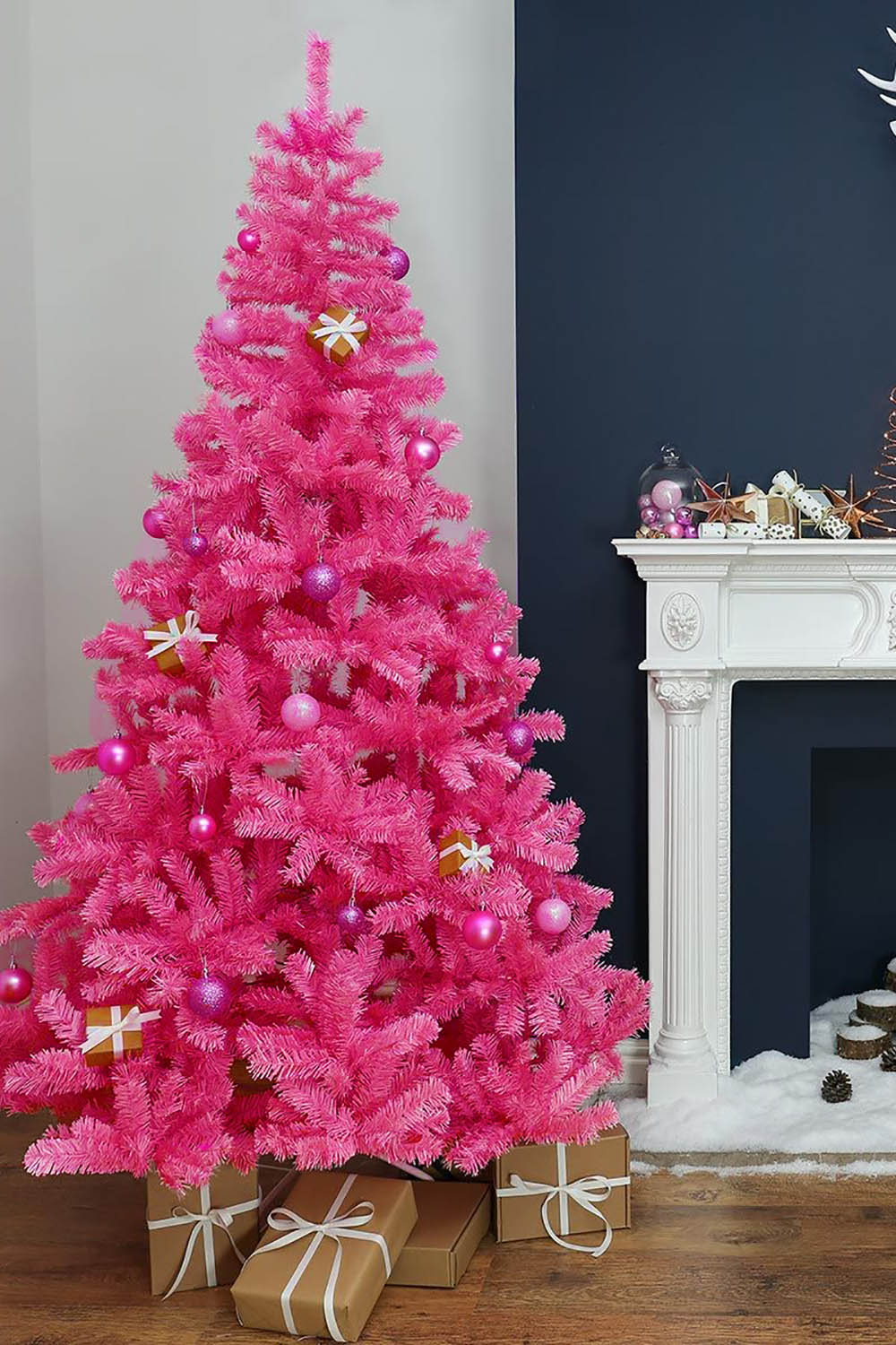 Pink artificial Christmas tree with gold star topper and pink ornament baubles