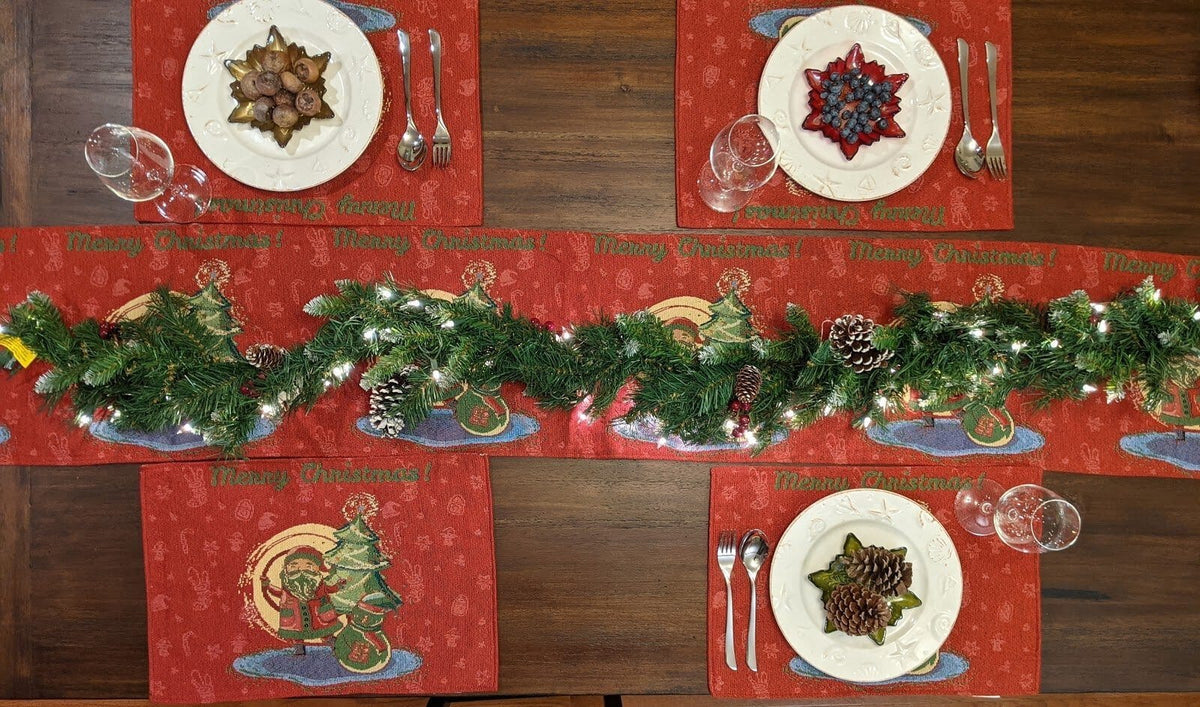 Red Christmas tapestry placemats set with Santa graphics across the tabletop