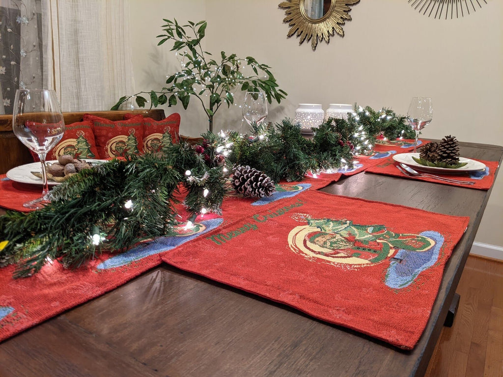 Red Christmas tapestry placemat with Santa and Merry Christmas text on dining table