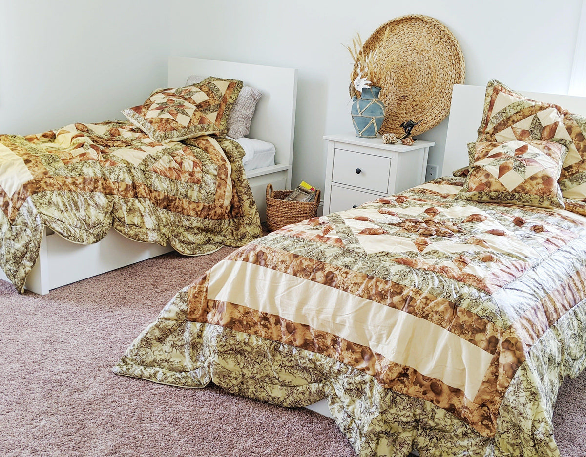 Patchwork camo-style comforter set in beige, brown, and green with two square pillows