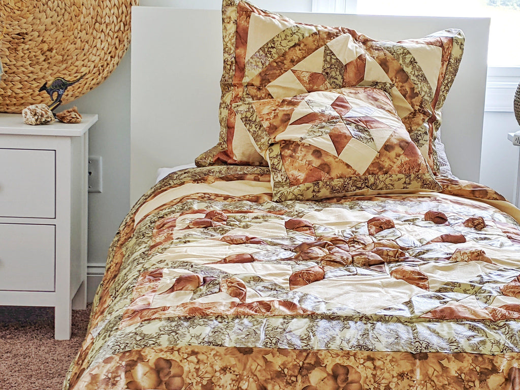 Earthy beige, brown, and green comforter with patchwork quilt and matching pillow set
