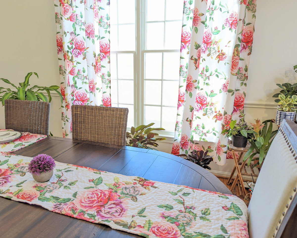 Quilted dining table runner with pink and red roses on a white floral background