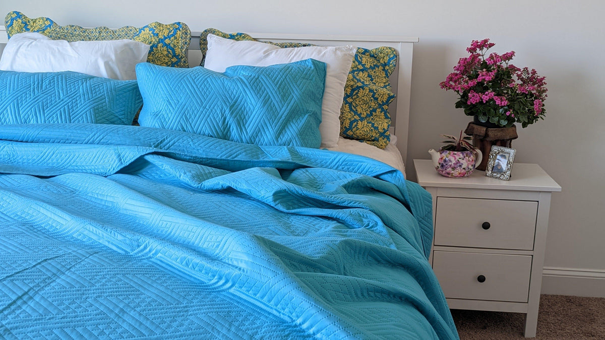 Turquoise teal quilted bedspread with gentle wave stitch pattern; includes pillow shams