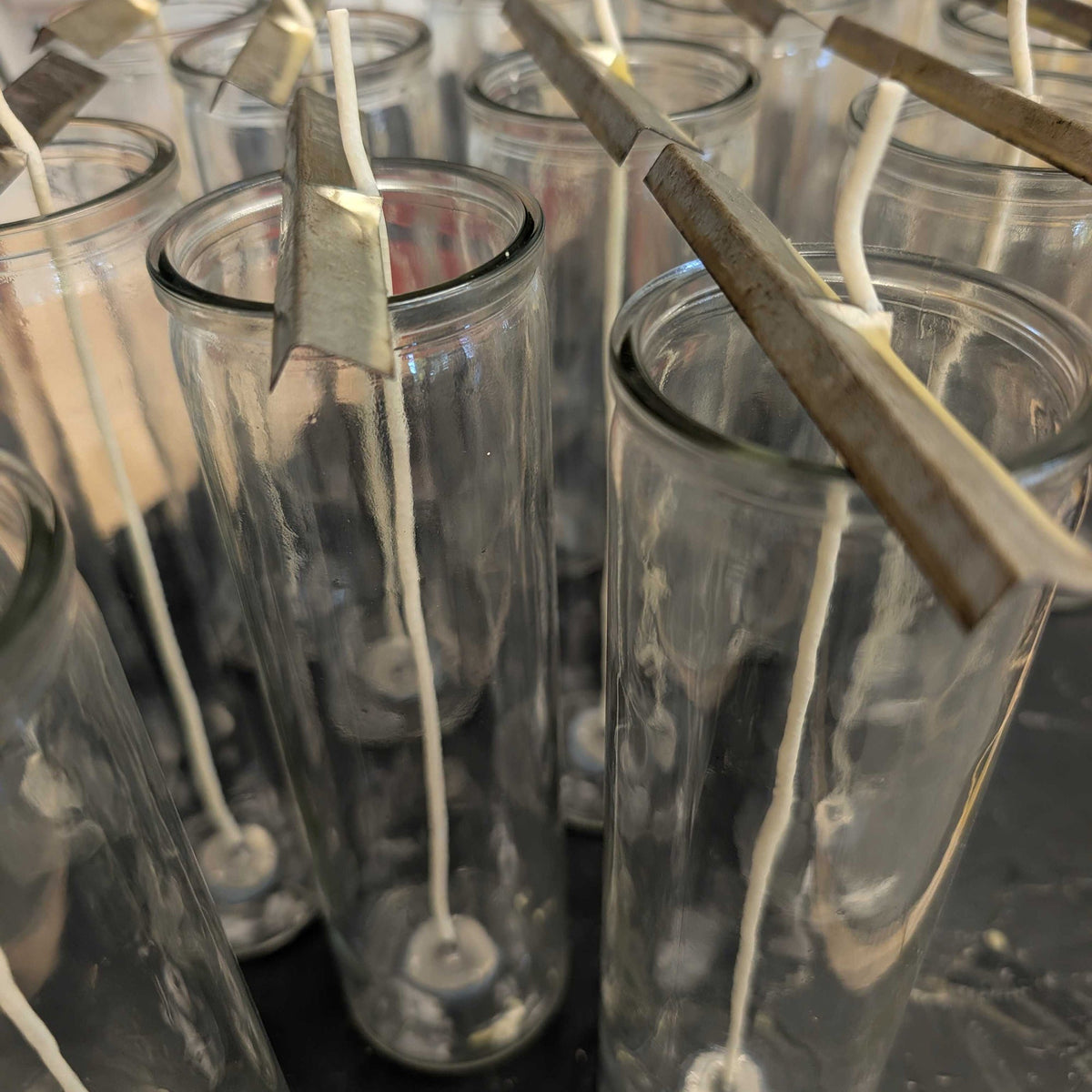 Clear glass candle containers with multiple straight wicks inside