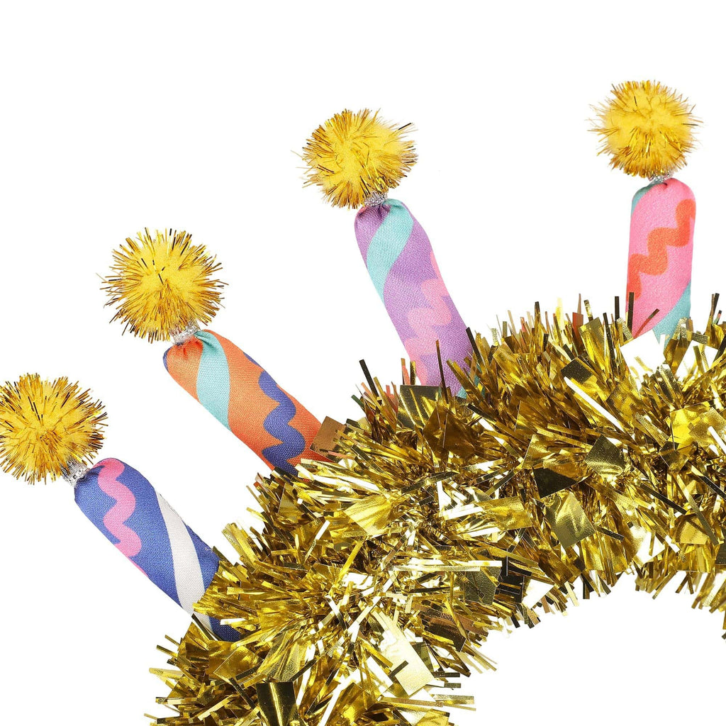 Gold glitter headband with colorful candle-pattern strips and yellow pom-pom accents