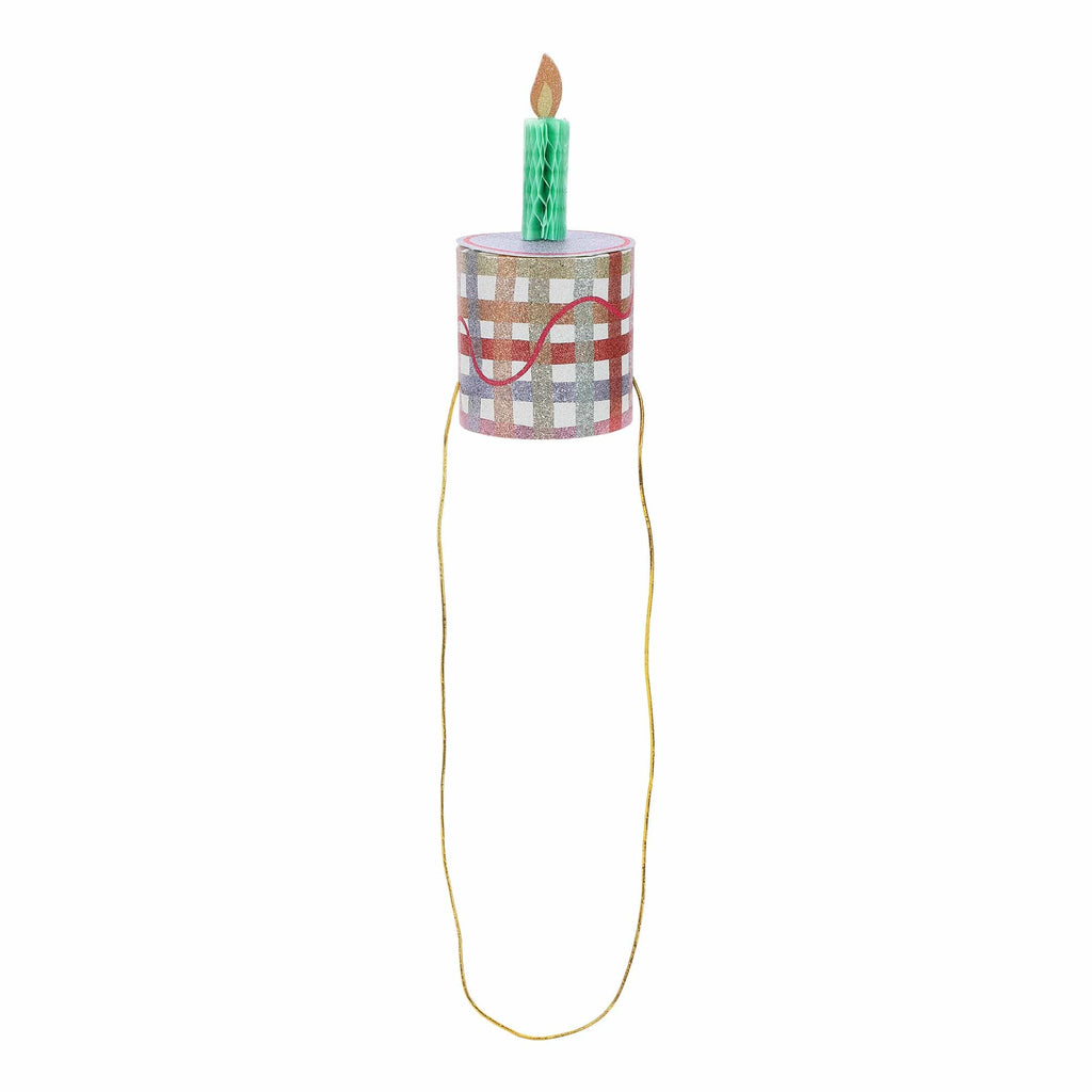 Mini birthday cake party hat with green candle topper on checkered cylinder and long gold cord