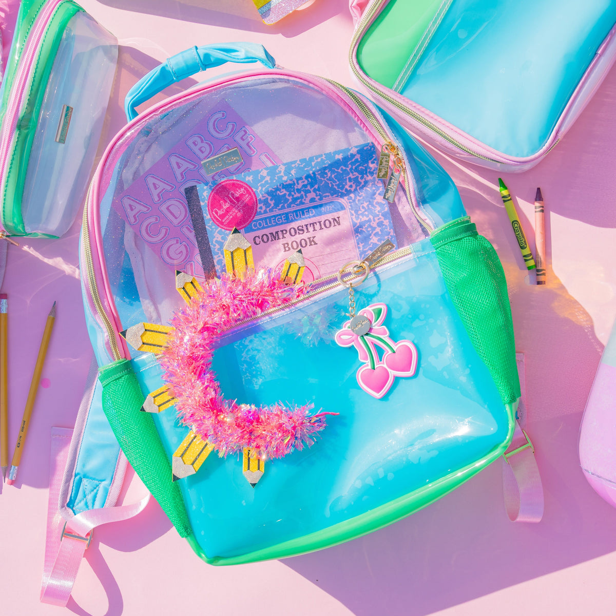 Clear color block jelly backpack with green sides and pink accents, front pocket charm