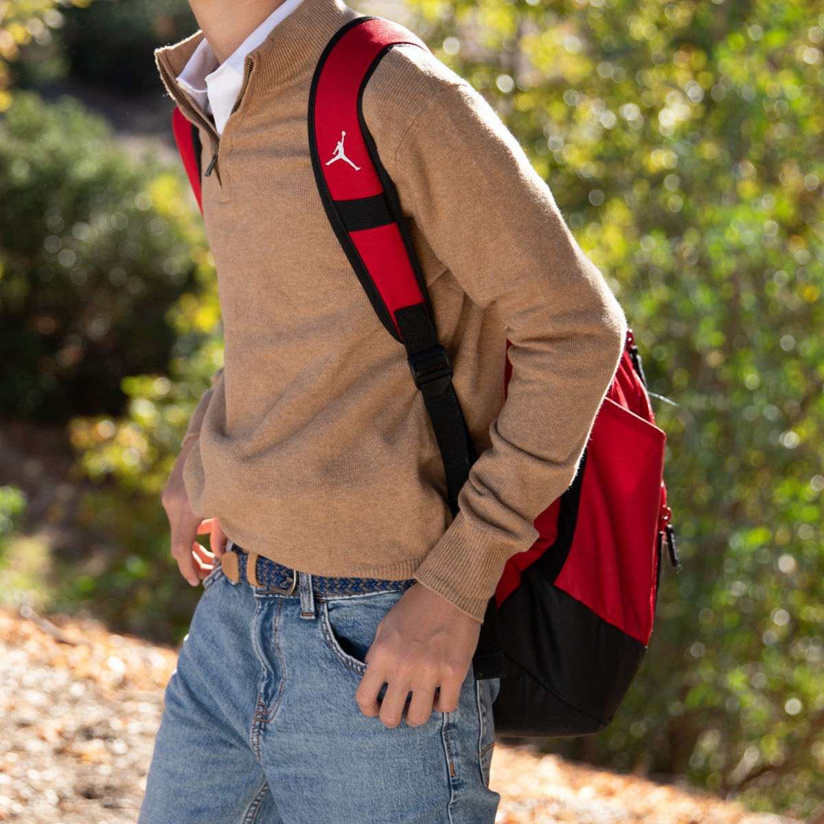 Boys stretchy woven belt with red and black strap, tan leather ends, metal buckle