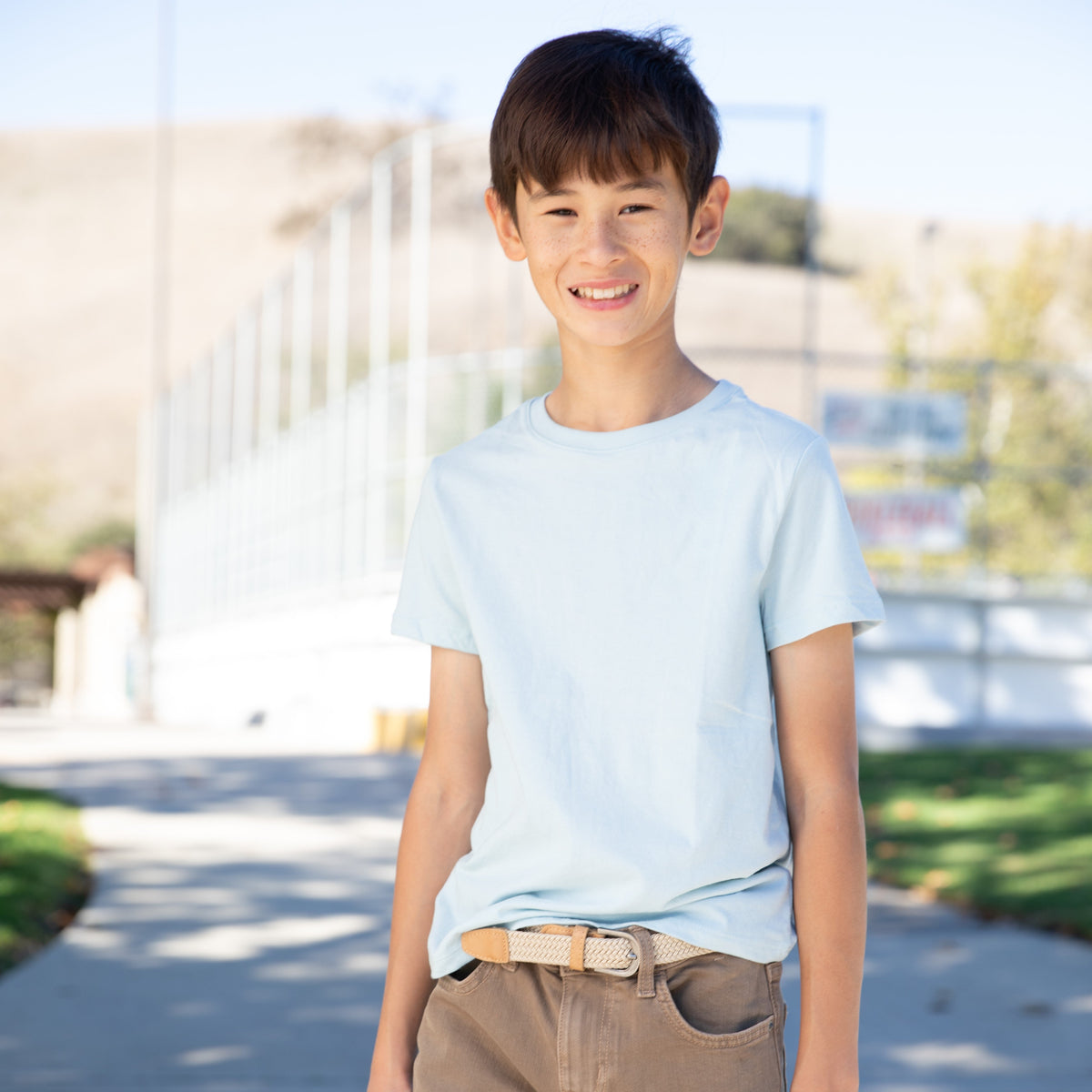 Stretchy leather belt for boys, tan woven strap with square buckle detail.