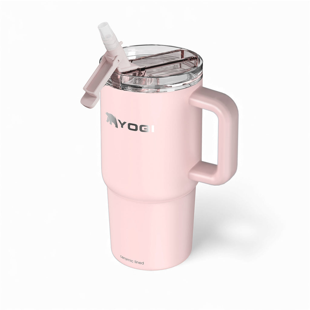 Ceramic-lined tumbler in pale pink with clear lid and handle, lid raised.