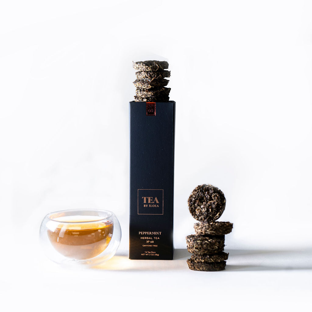 Peppermint tea box with stacked tea discs and a cup of brewed tea