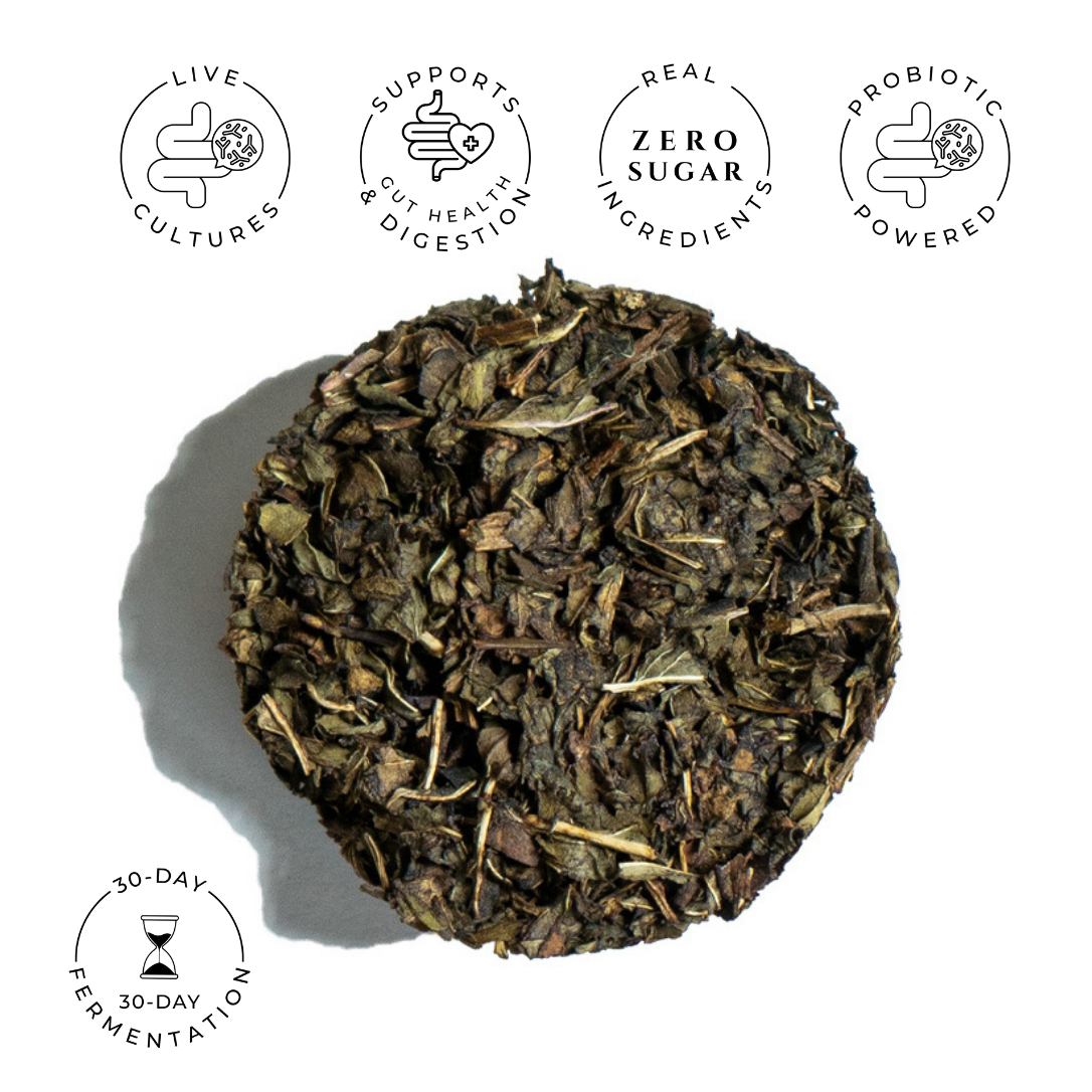 Round compressed peppermint tea disc made from dark leaves and stems