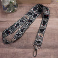 Black pet lanyard with white mothman-style graphics and metal clip