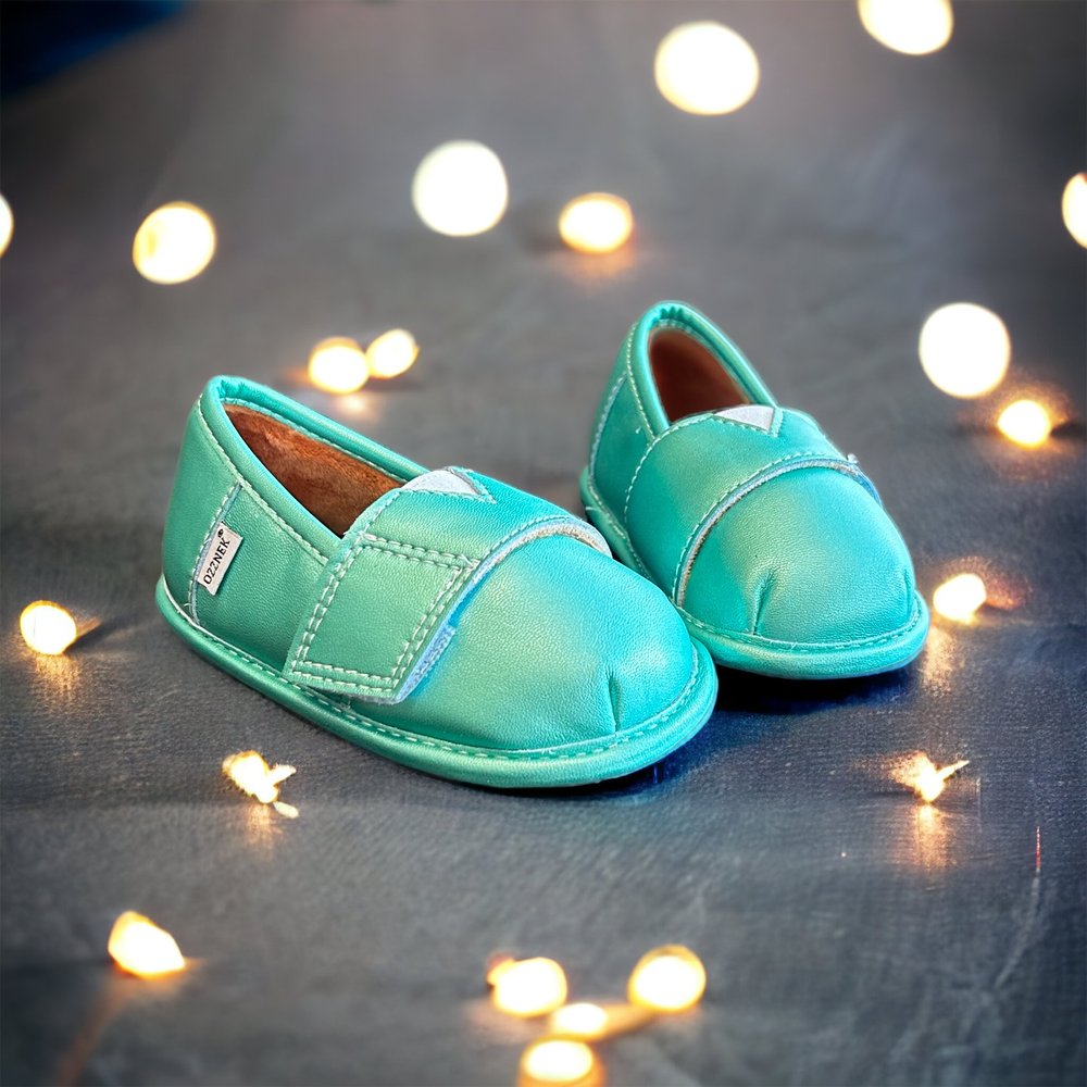 Pair of teal slip-on barefoot shoes with contrast stitching and rounded toe