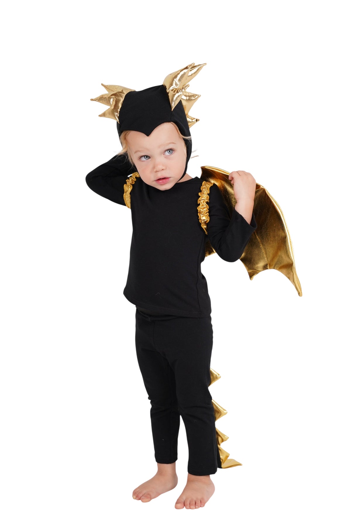 Black dragon costume on child with gold tail-like strap, wing cape, and horn headpiece