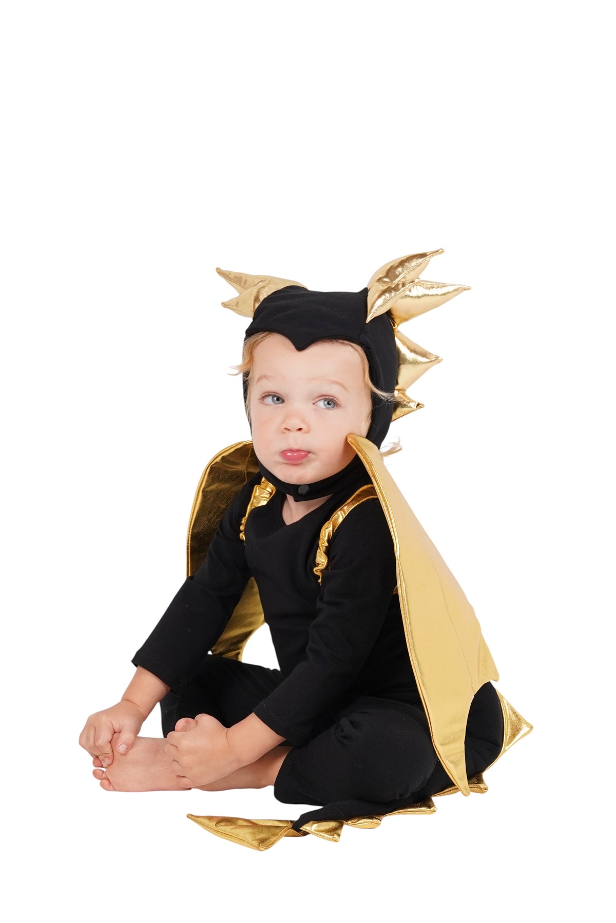Baby black dragon Halloween costume with gold horn headpiece and draped gold cape