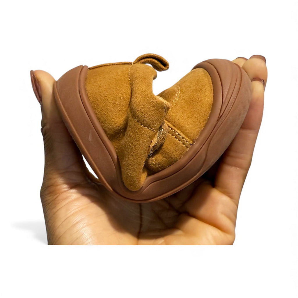 Kids' tan barefoot sneakers shown in hand, back and sole profile visible