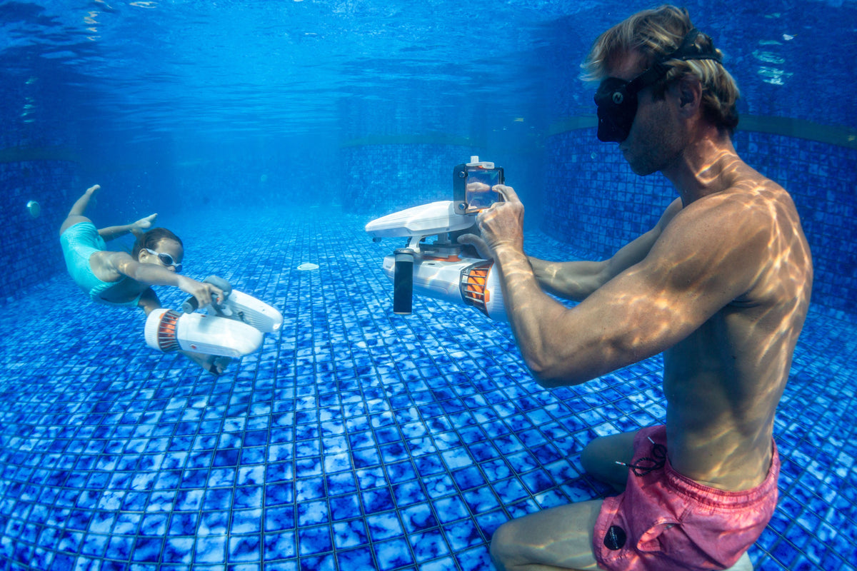 Waterproof phone case with clear housing and open controls, held underwater.