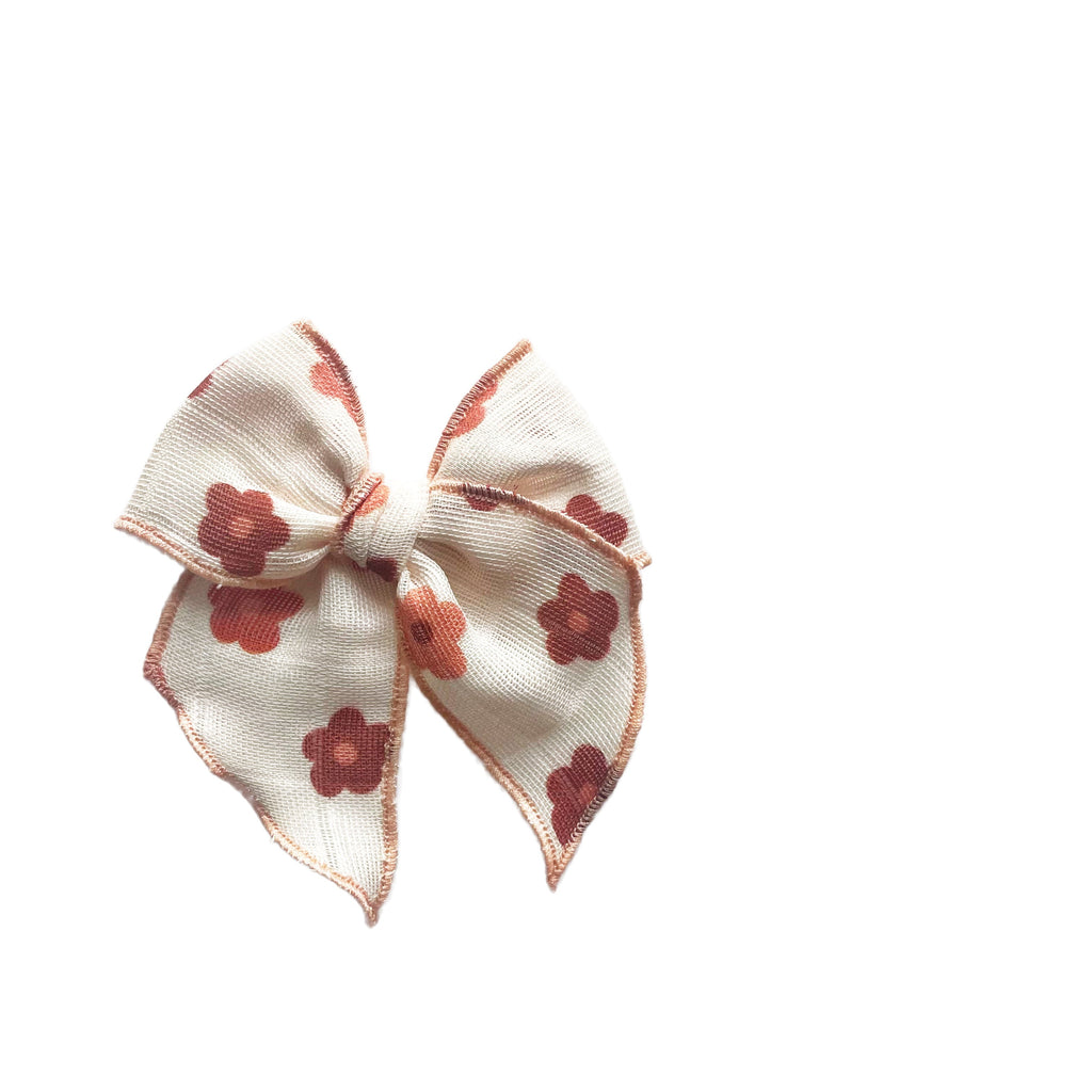 Cream gauze bow with red clover daisy pattern, layered loops with stitched edges