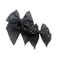 Dark grid fabric bow with tied center and layered pointed tails