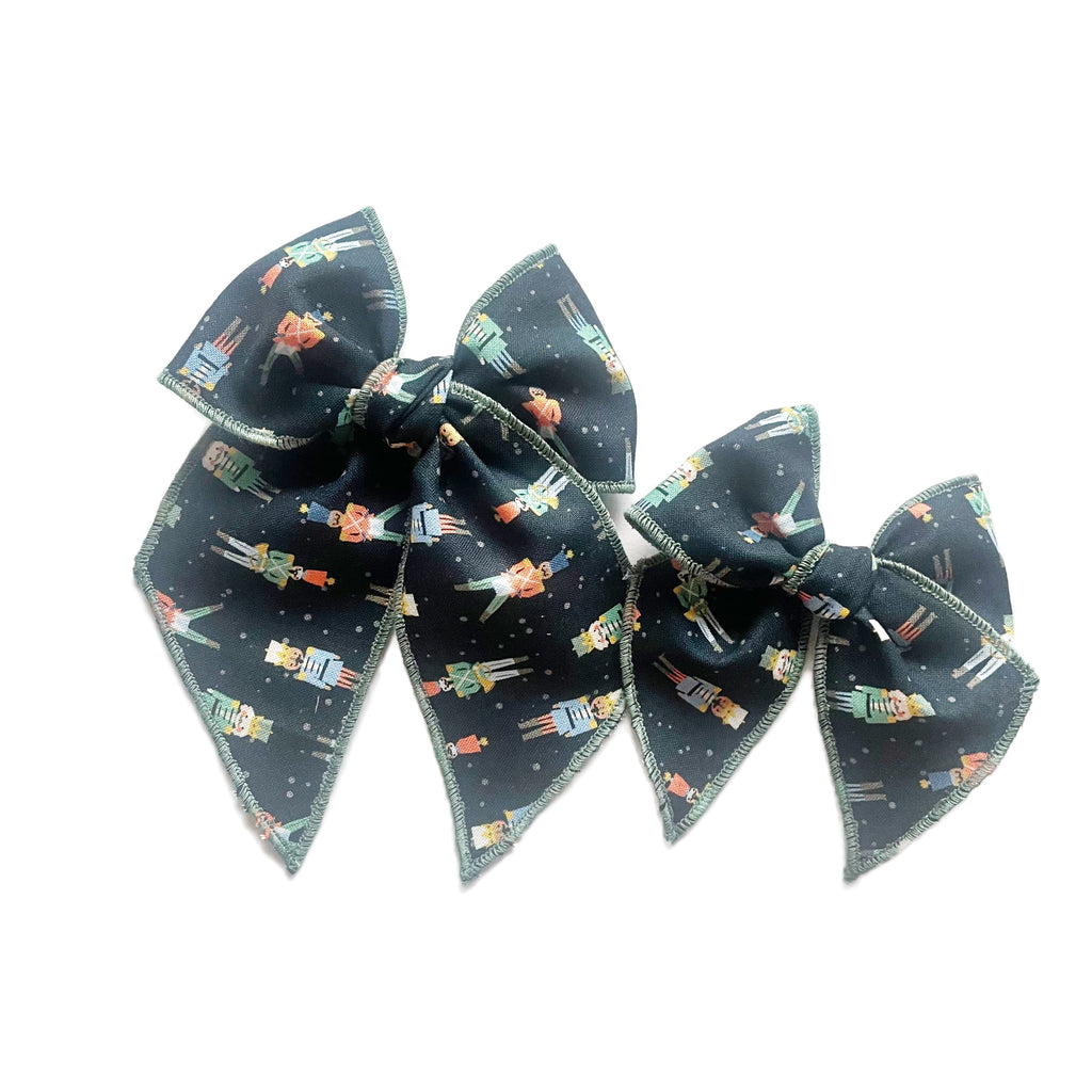 Dark blue nutcracker print layered hair bow with center knot and long tails