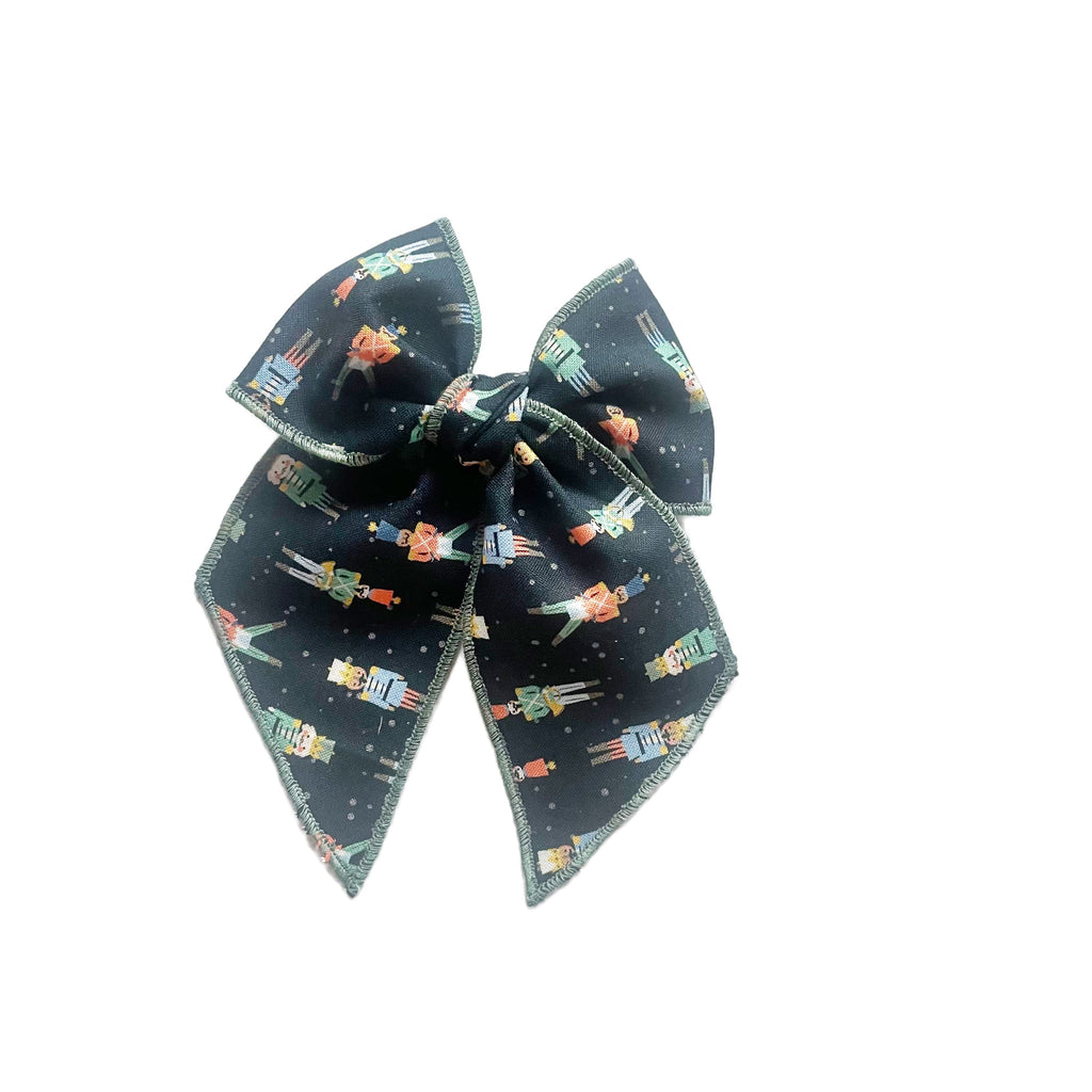 Dark blue nutcracker print hair bow with stacked loops and pointed tails