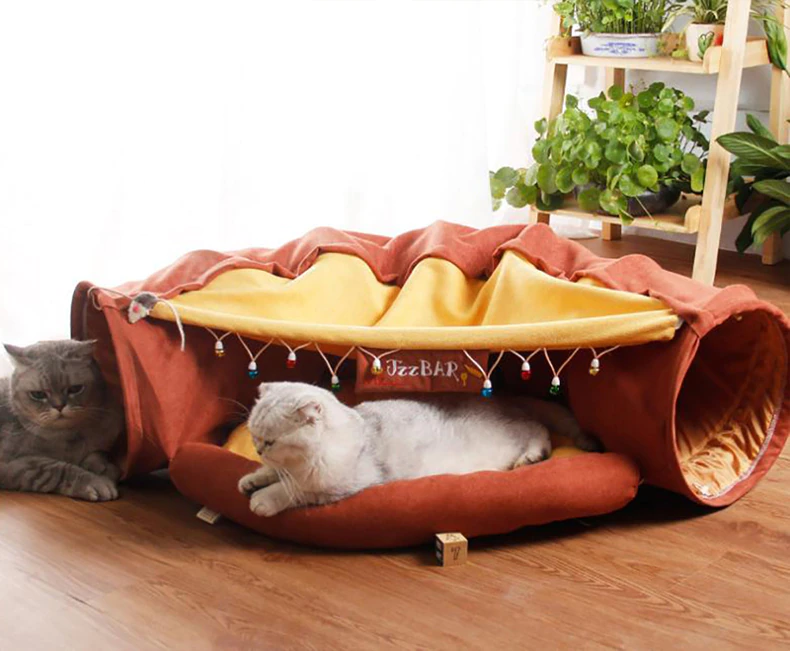 Cat tunnel tube with dangling toys and plush bed, with two resting cats