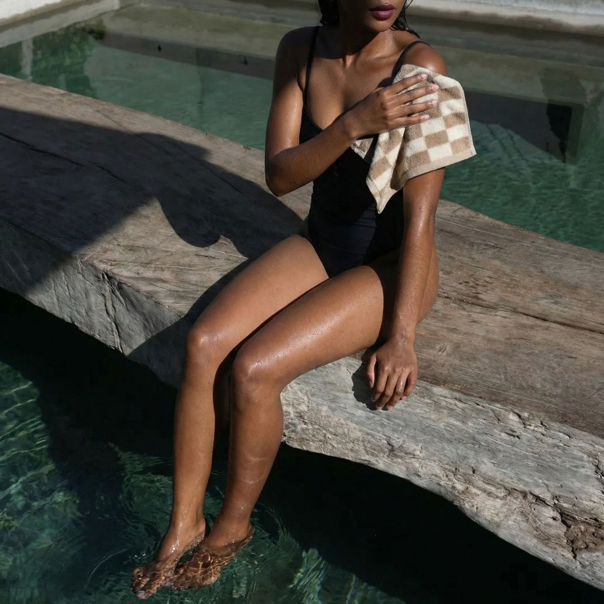 Cotton checkered towel held to shoulder in tan and cream blocks