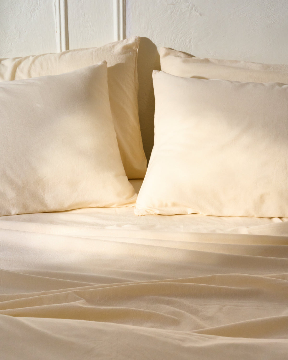 Cream sheet set laid on a bed with matching pillowcases and flat sheet