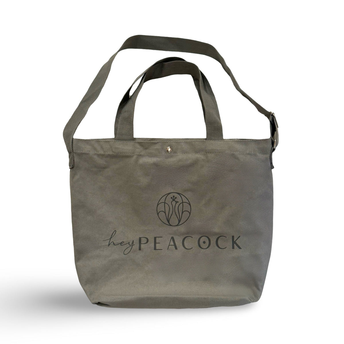 Gray canvas tote bag with two handles and heyPEACOCK logo on front