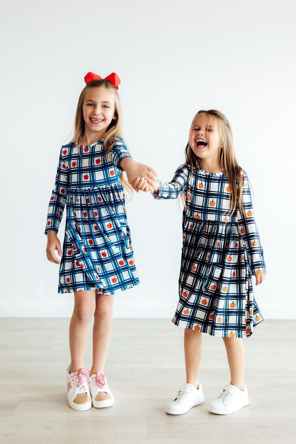 Plaid long-sleeve girls twirl dress with pumpkin print and front pocket, blue and orange