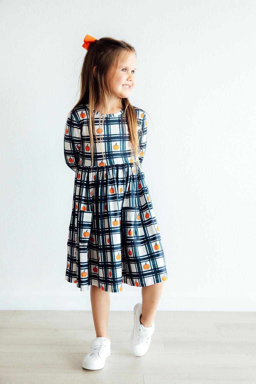 Plaid long-sleeve twirl dress with pumpkin print, front pocket, blue white black grid