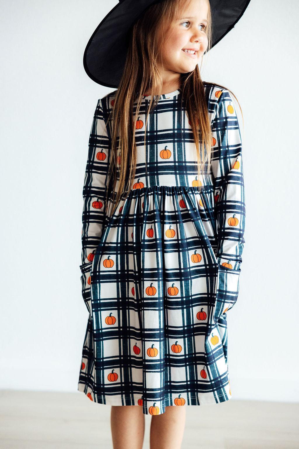 Girls long-sleeve plaid twirl dress with pumpkin print and front pocket, blue black white