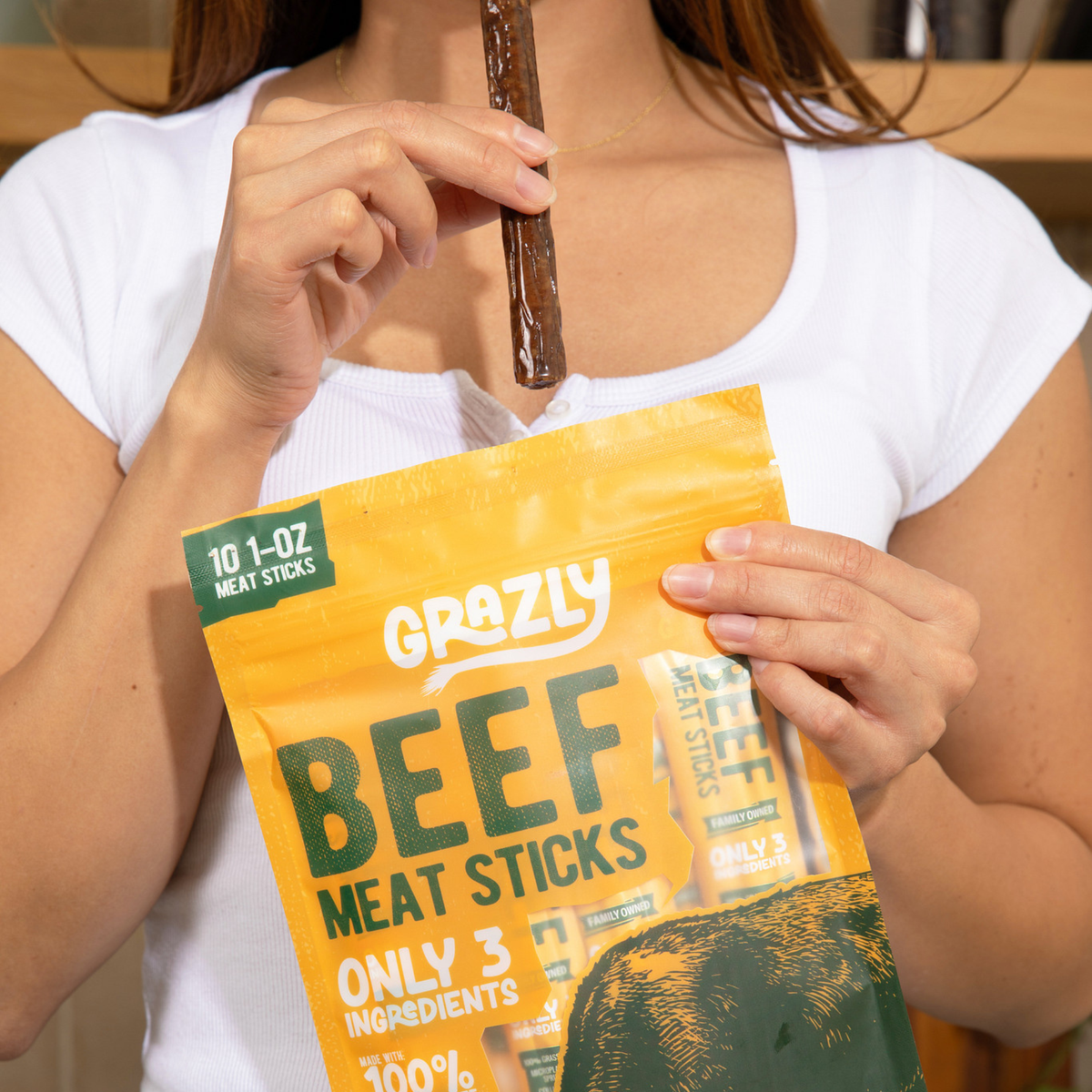 Beef meat sticks pouch held by person in white shirt