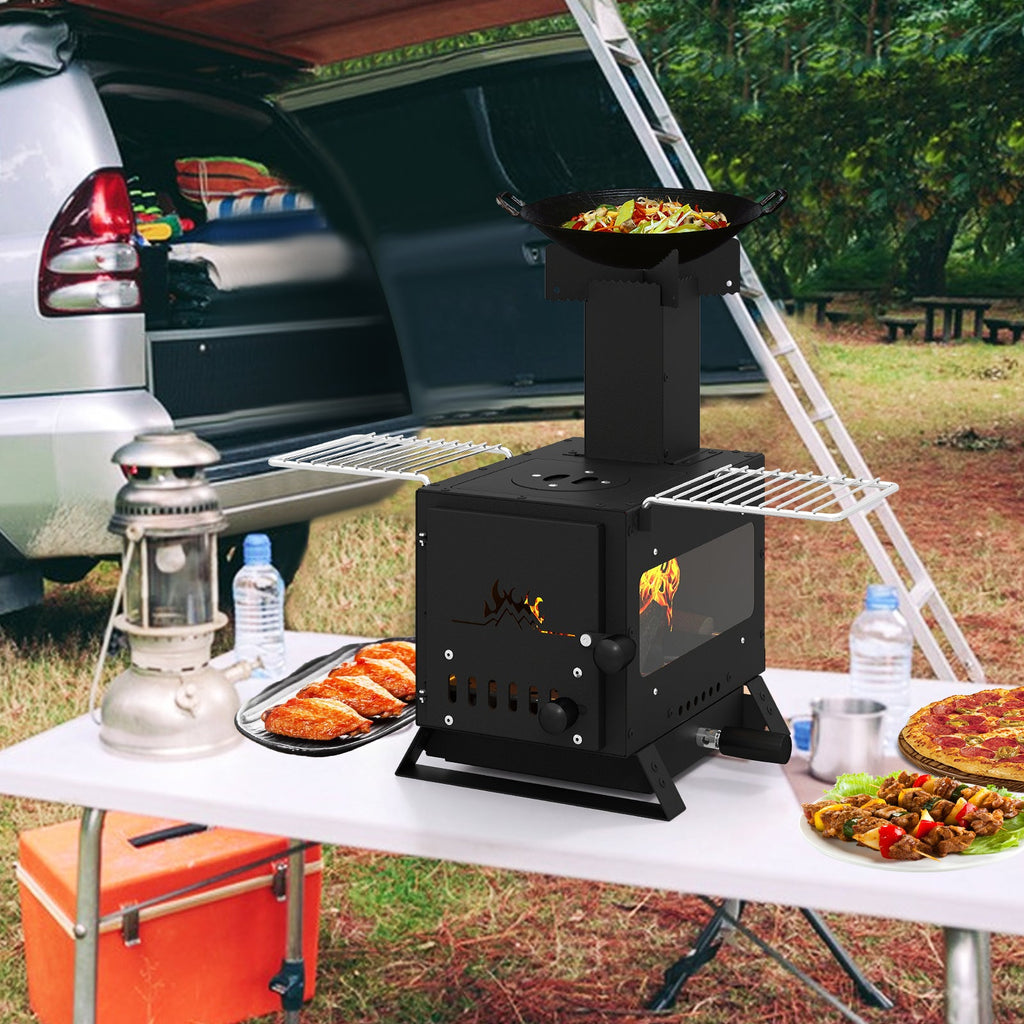 Black mini wood stove with pot rack on table, oven door open with flames