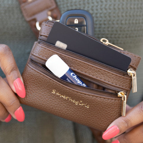 Brown zippered pouch with 3 zippers and gold key ring, holds cards