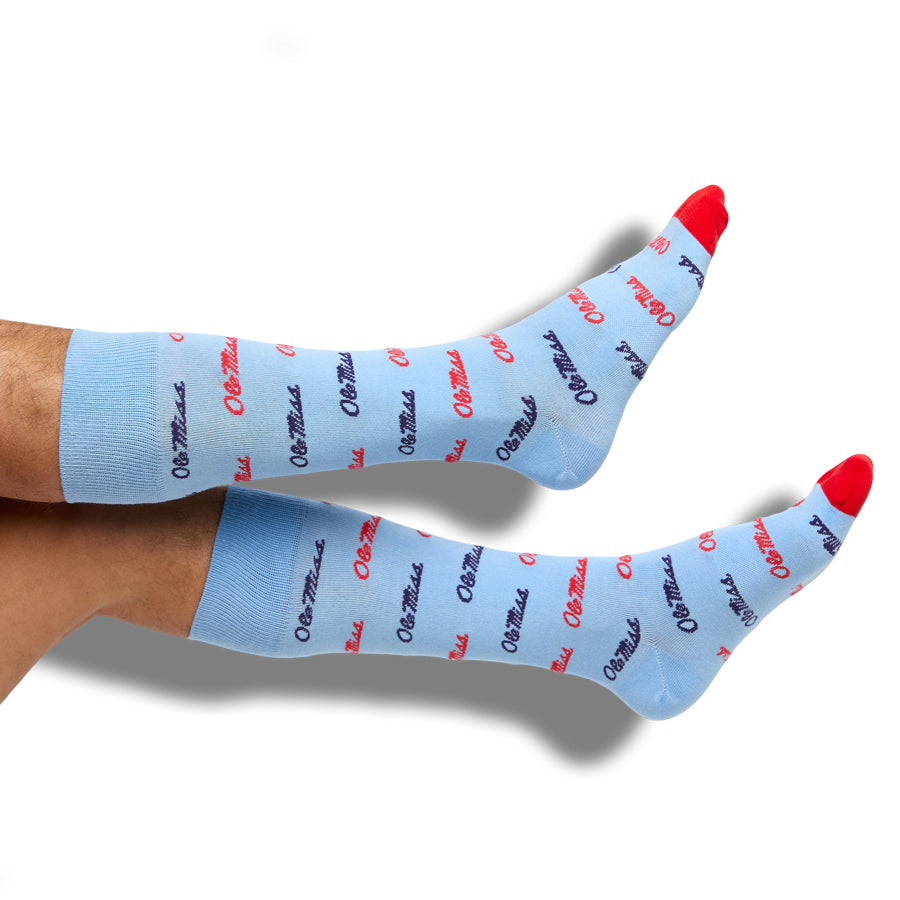 Light blue crew socks with repeating red and black script and red heel accents