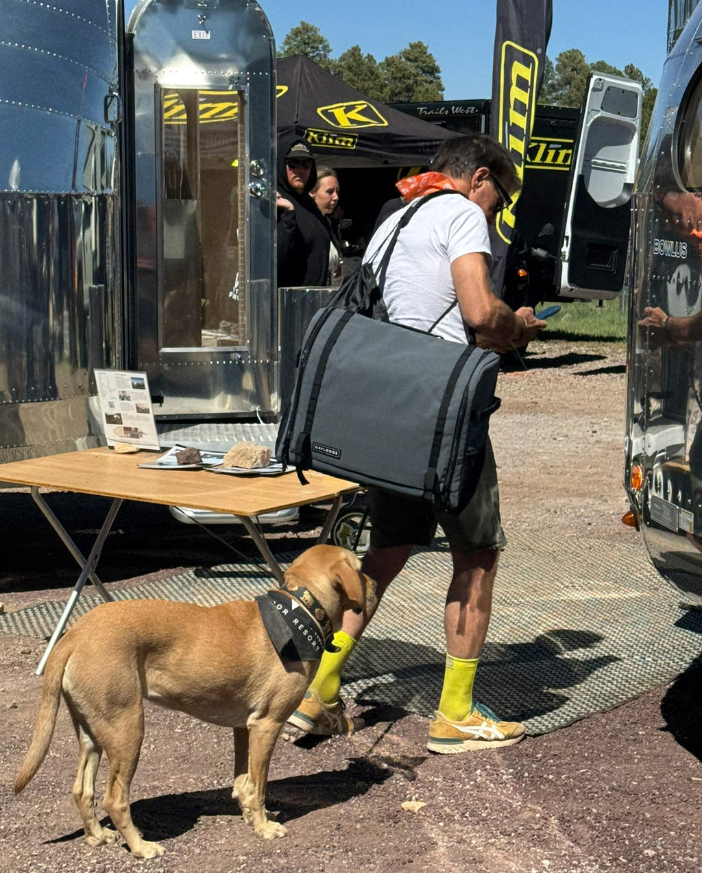 Mobile camp kitchen storage bag on person’s back with two front compartments