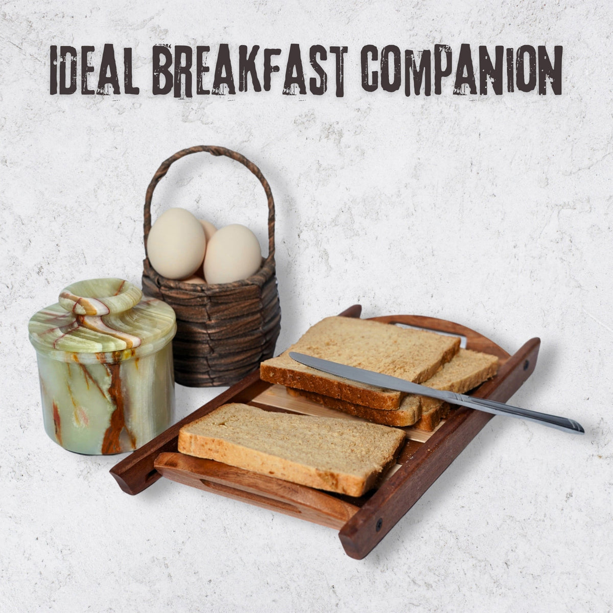 Green onyx butter crock with lid beside bread and eggs, decorative ceramic butter keeper