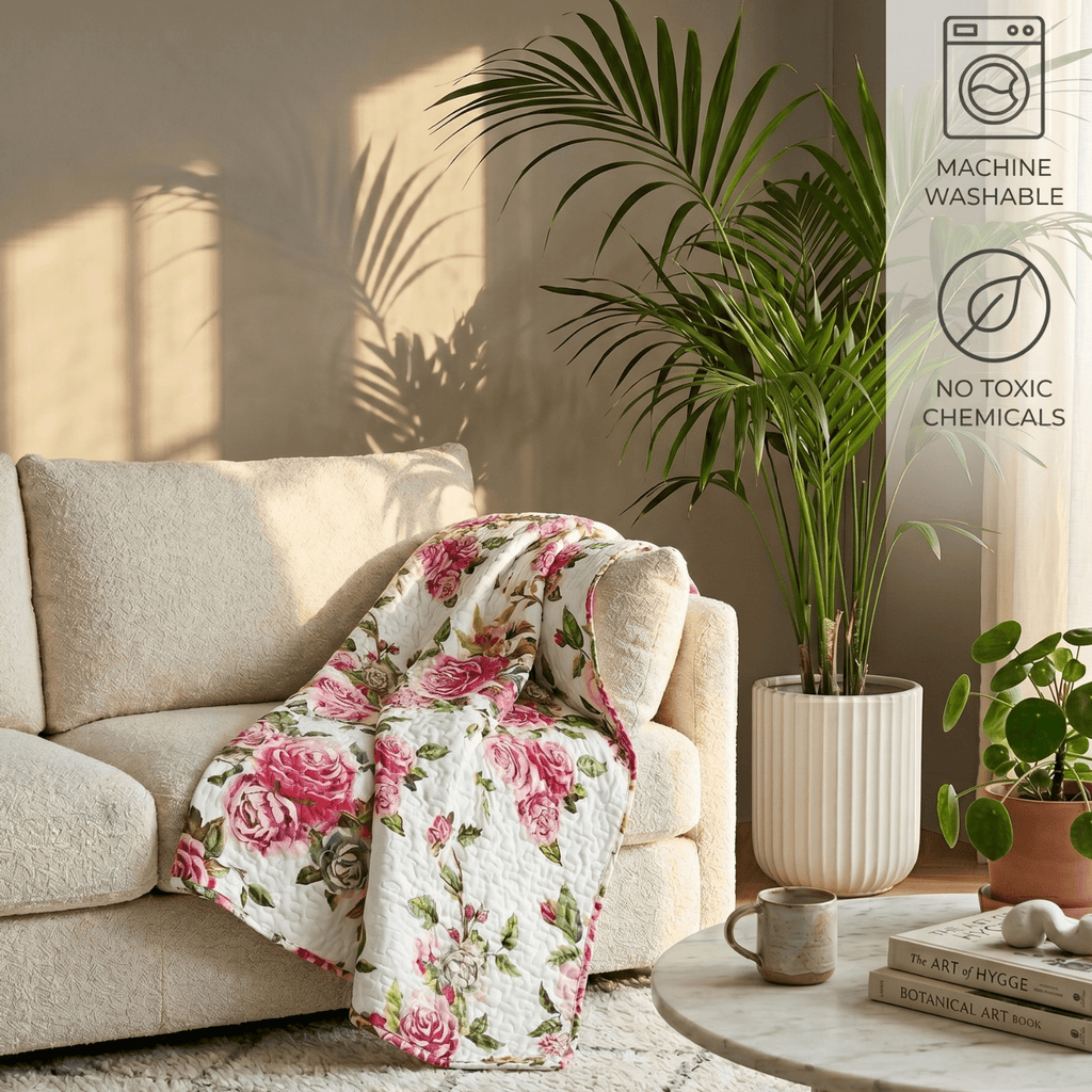 Lightweight quilted throw blanket with white background and pink roses with green leaves