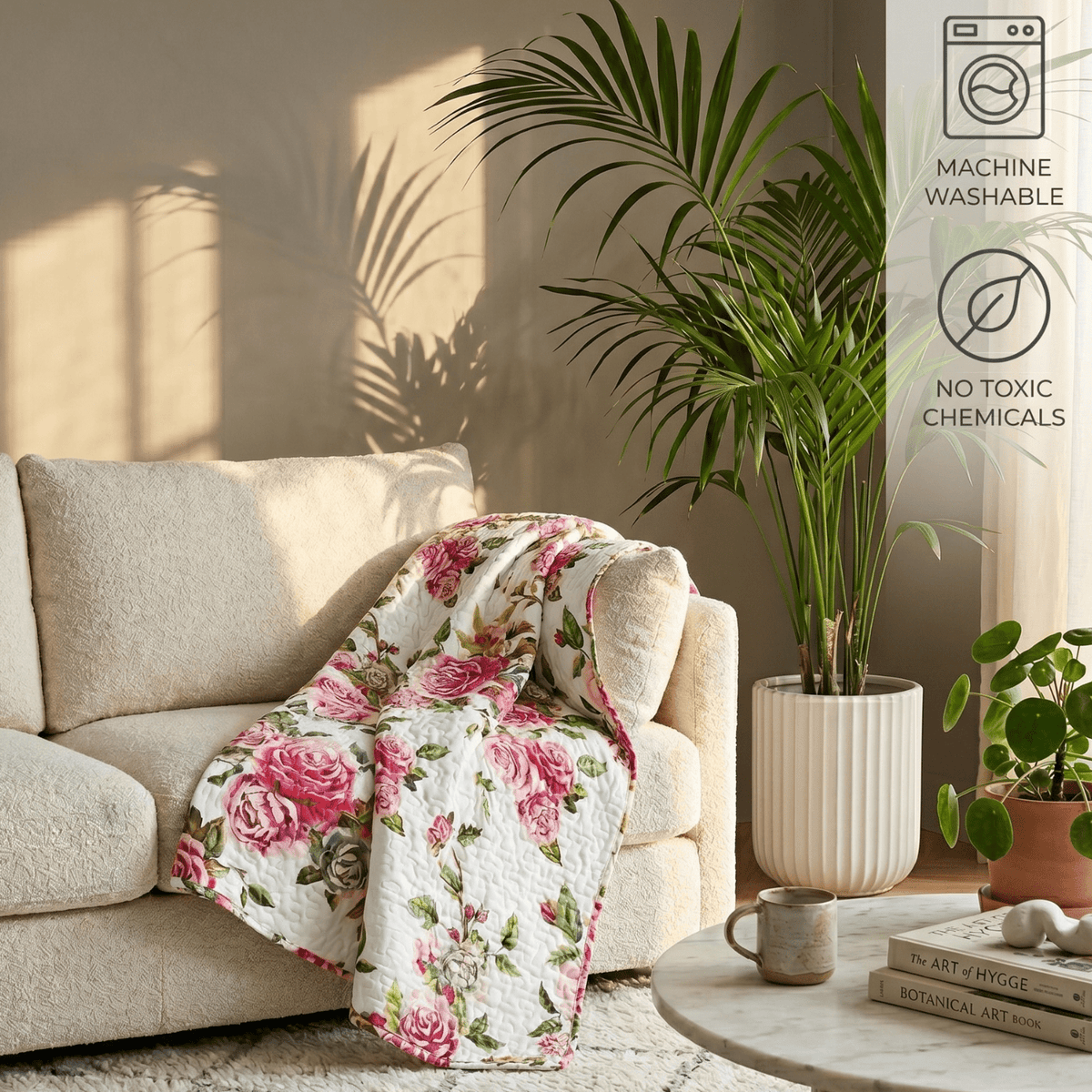 Lightweight quilted throw blanket with white background and pink roses with green leaves